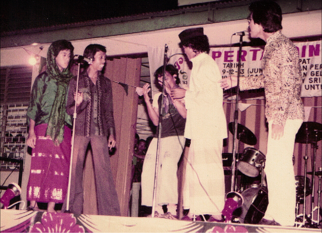 Four performers in Malay traditional clothing, performing at the Boria Seminar 1987