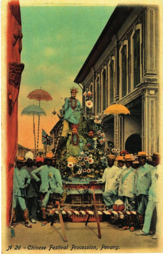 A colourised photo of a parade float and a group of men surrounding it, dressed in blue.