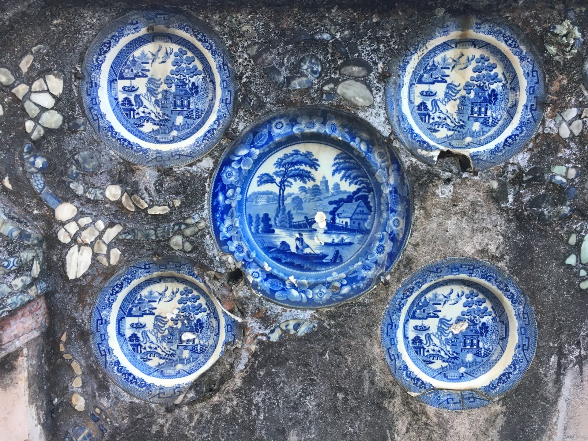 Blue and white ceramics embedded in a stone wall.