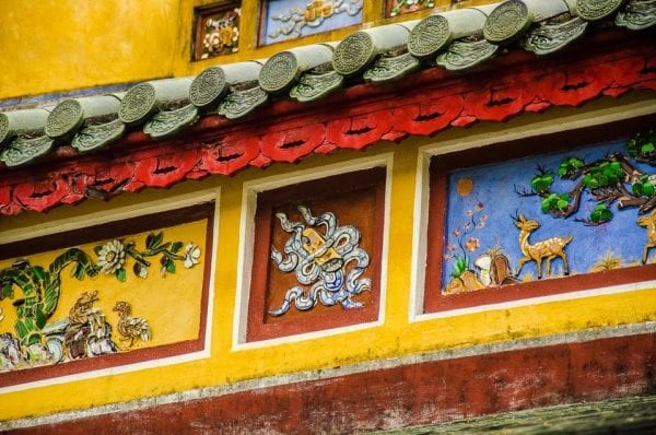 Some painted architectural detail. The paint is in bright yellow, red and blue.