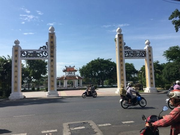 A view across a road towards the citadel. The sky is blue.