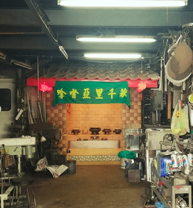 A shrine inside a large room lit with fluorescent lights.