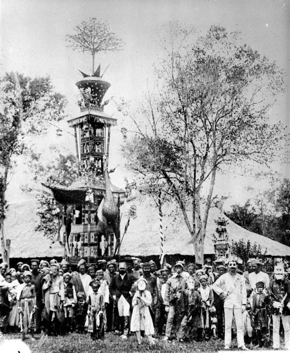 A black and white photo of a large festival sculpture.