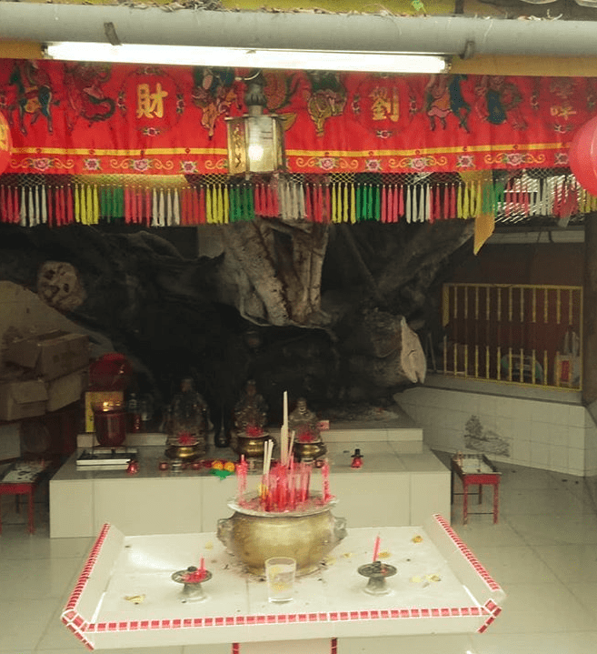 A shrine with incense and colourful decorations.