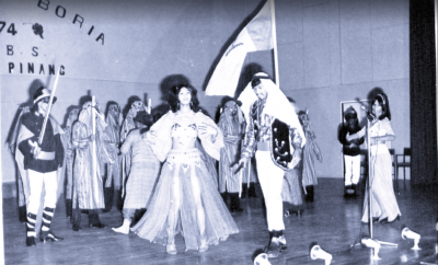 Black and white image of group in costume performing Boria 