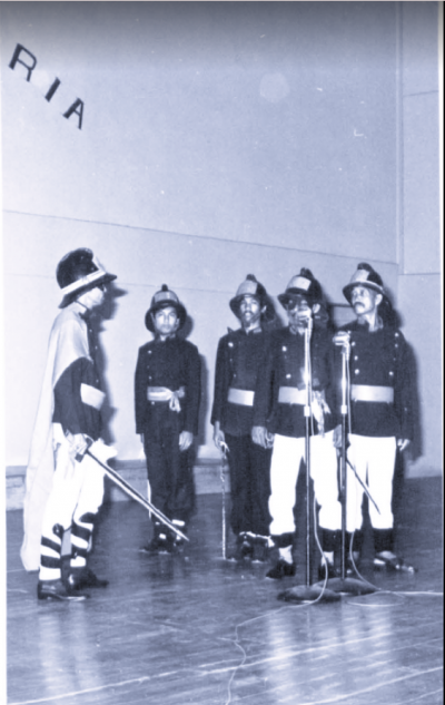 Black and white picture of Boria Seminar performance. Men in uniform.