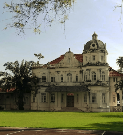 A large white-walled colonial mansion.