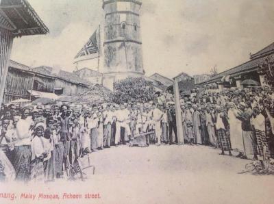 A black and white photograph of a crowd in front of the Malay mosque.