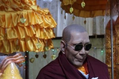 A monk wearing sunglasses.