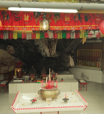 A shrine with incense and colourful decorations.