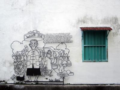 A piece of wrought-iron art showing an old man selling rock candy.