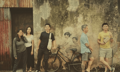 Five members of the Penang research team posing with some street art.