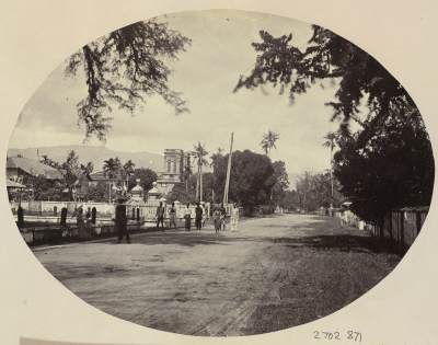 Black and white photo of people walking by the water.