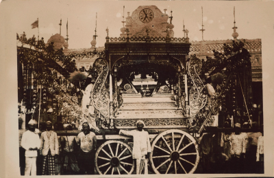 A black and white photo of a decadent carriage for the procession.