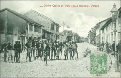 A black-and-white photo of convicts at work on the road.