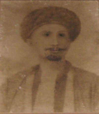 Sheikh Omar, who has a moustache and wears a turban.