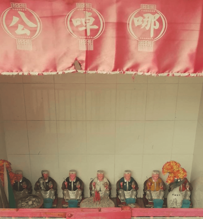 Statuettes lined up in a shrine.