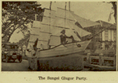 Sungei Glugor Party on a parade float decorated as a boat.