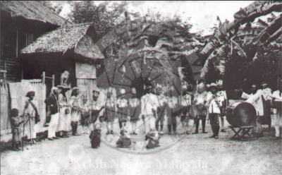 Troupe of performers with musical instruments and costume attire.